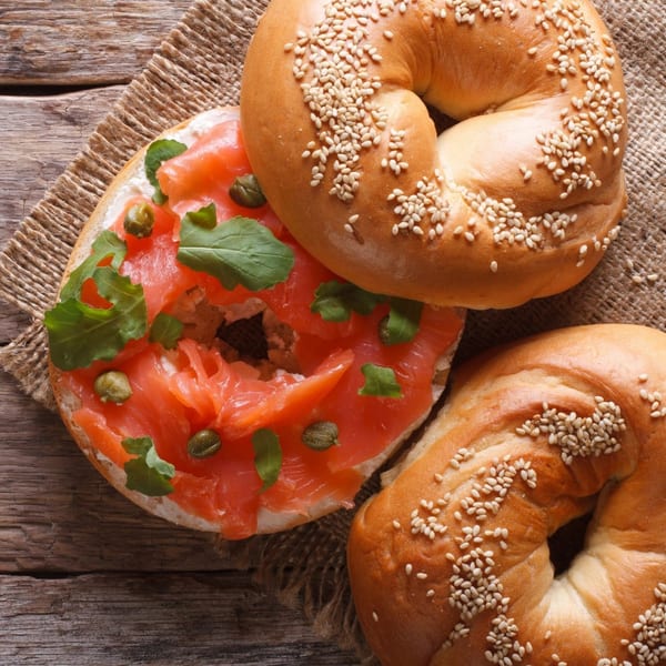 New York Bagel Company sesame bagels with cream cheese, smoked salmon, capers, and arugula.
